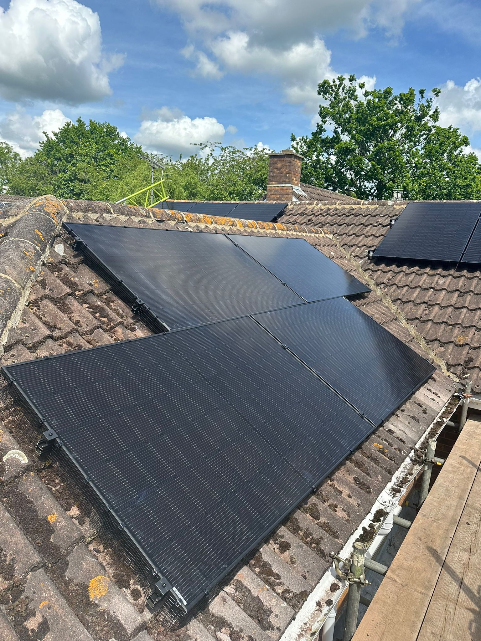 All black Jinko 435w solar panels installed on a concrete tile roof. 