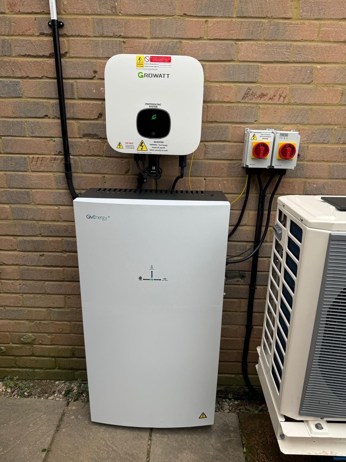 A Growatt inverter with a GivEnergy All-in-One installed next to a customer's heat pump.